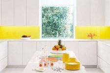 22 an all-white kitchen with a bold yellow backsplash to add a colorful touch and raise your mood