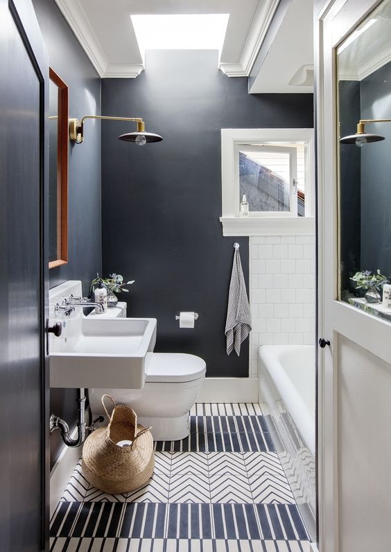 Black walls and white tiles contrast and make a cool and eye catchy space