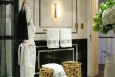 22 gold geometric stools and brass fixtures and details thoughout the bathroom add a glam feel