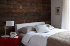 23 a dark reclaimed wooden wall adds a bold touch and texture to the modern bedroom