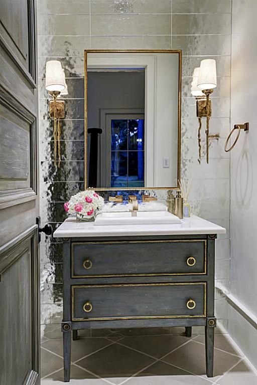 a greyish blue vanity with a marble top looks very cool and chic