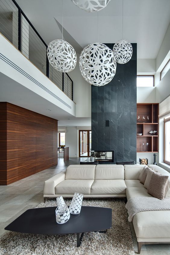 A saturated wooden wall and a black stone fireplace wall define this modern space