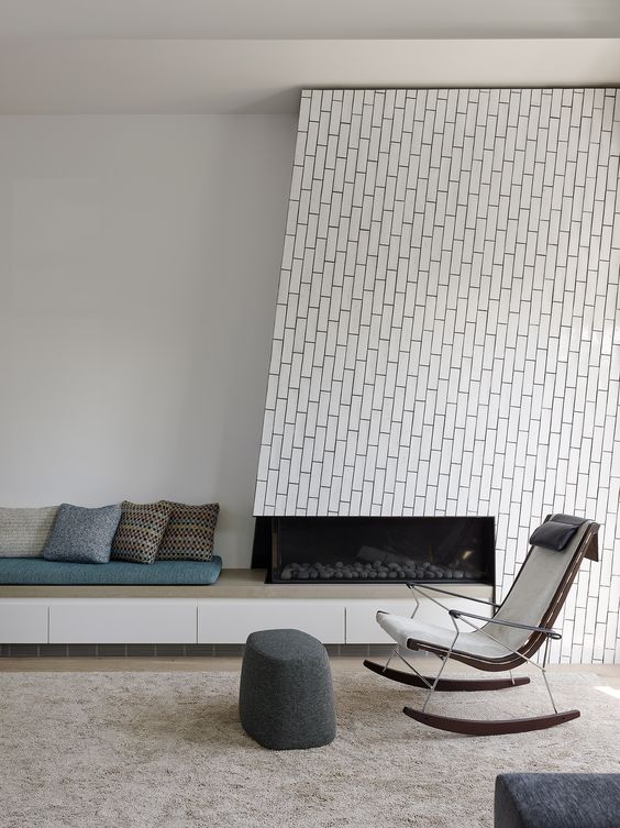 white tiles that imitate bricks and are clad using an eye-catchy pattern are amazing