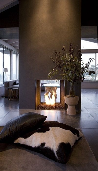 a bold concrete fireplace with a glass part is a great fit for a modern cabin and it brings more texture to the decor
