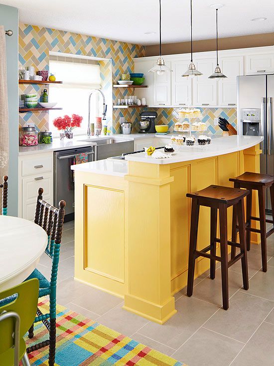 a colorful kitchen with a yellow two-level island that includes a breakfast zone