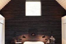 24 a fantastic cabin bedroom with a black wooden wall for a bold statement in a neutral space