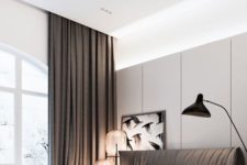 24 a modern bedroom with an upholstered brown bed and matching curtains, and cool large glass sphere lamps on one side