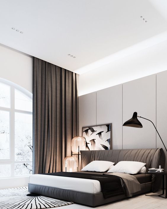 a modern bedroom with an upholstered brown bed and matching curtains, and cool large glass sphere lamps on one side
