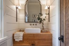26 a rustic butcher’s countertop makes a statement in this powder room, and baskets under it add a cozy feel