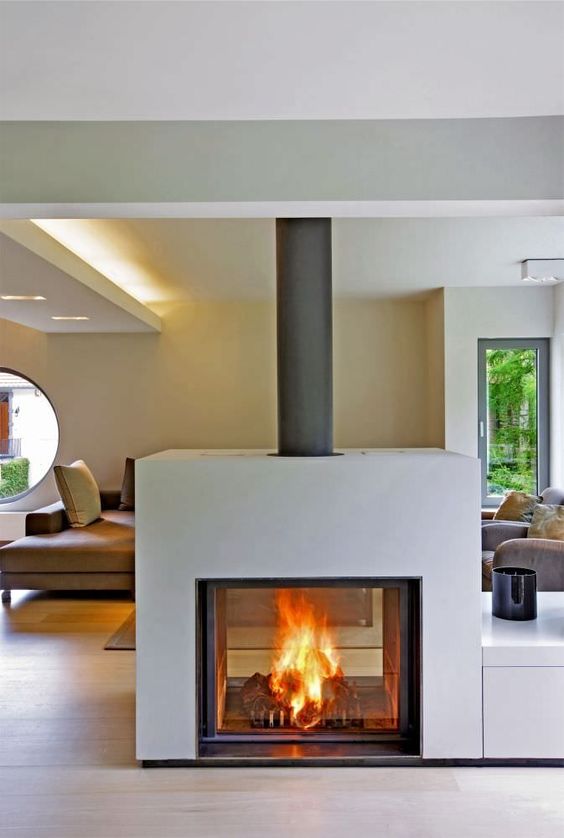 a wood burning closed stove visible from both sides is a gorgeous modern idea to bring warmth