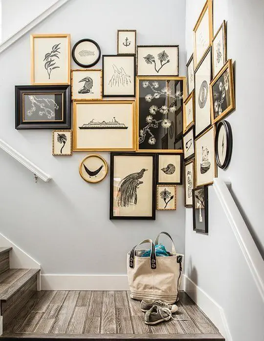 an awkward staircase corner with a gallery wall in gold, white and black for a cool and vintage-inspired look