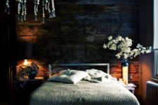 26 the base of this moody space is a very dark reclaimed wooden wall that sets the tone in the space