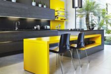 27 an ultra-modern kitchen with dark grey cabinets and a yellow kitchen island for a dining space
