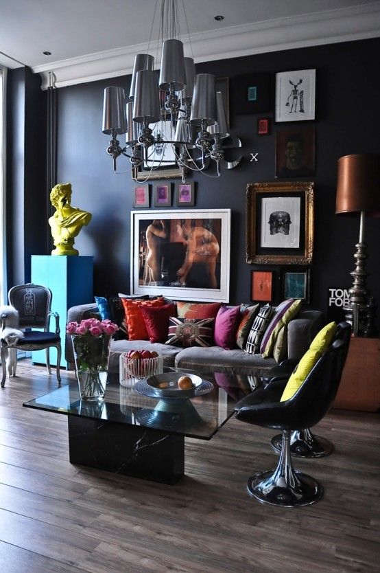 To balance a moody feel from the black walls, colorful textiles and artworks were used here, which made the space more contrasting