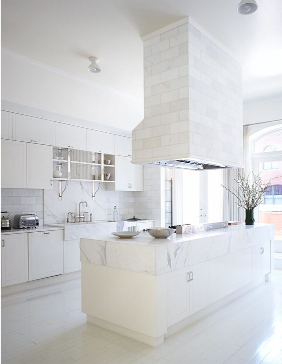 a white kitchen is added with a tile clad hood and backsplash and marble surfaces