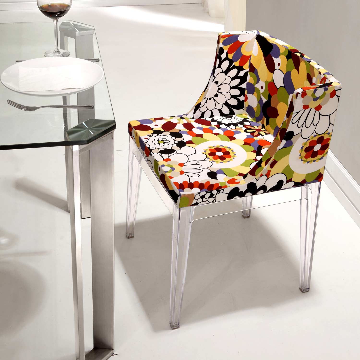 Pizzaro dining chair is a floral piece with acrylic legs and frame and is inspired by 1960s