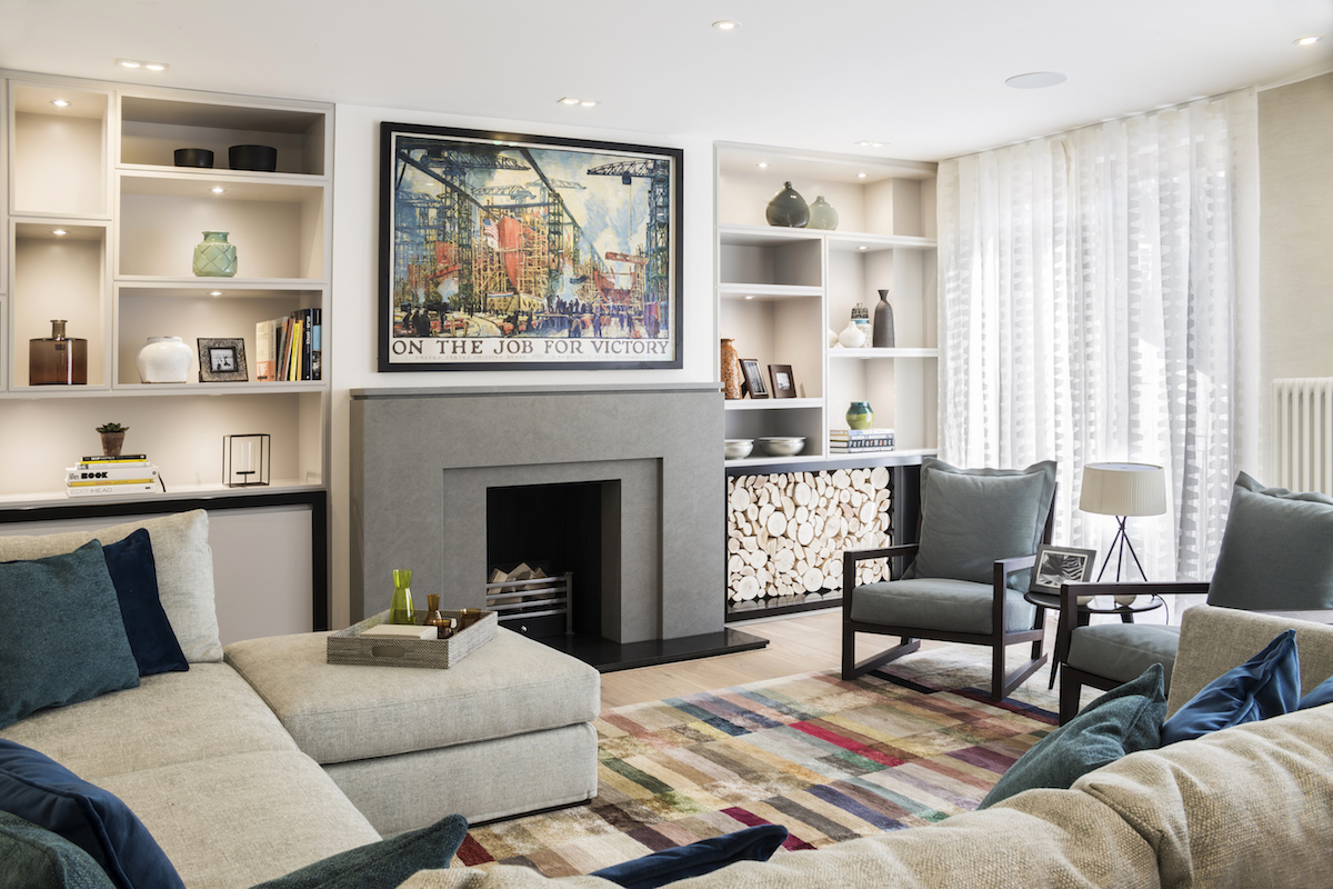 The living room on the third floor looks very welcoming with colorful touches and a stone fireplace