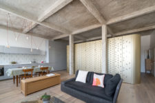01 This Parisian loft features an interesting piece – a central island with perforated panels that divides spaces and contains a bedroom inside