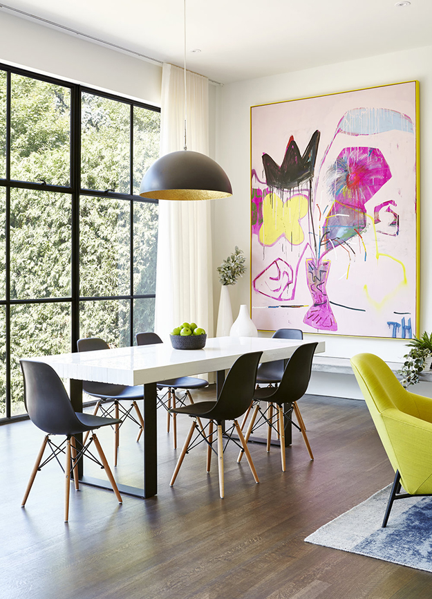 This modern dining space with a bold artwork and gorgeous views looks wow