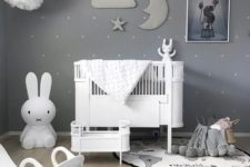 02 a beautiful grey nursery with a sky theme, paper pompoms and a stuffed cloud, moon and star