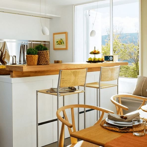 The kitchen island features a breakfast space or a mini bar countertop
