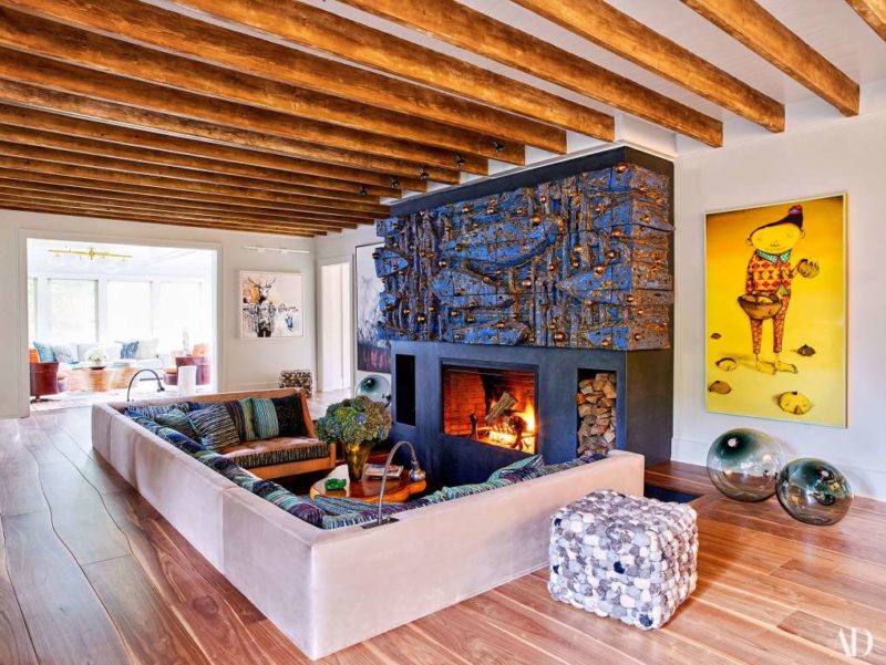 The living room features a sunken conversation pit and a unique fireplace done by an artist
