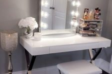 03 a glam sleek white vanity with metal trestle legs and a drawer for storage