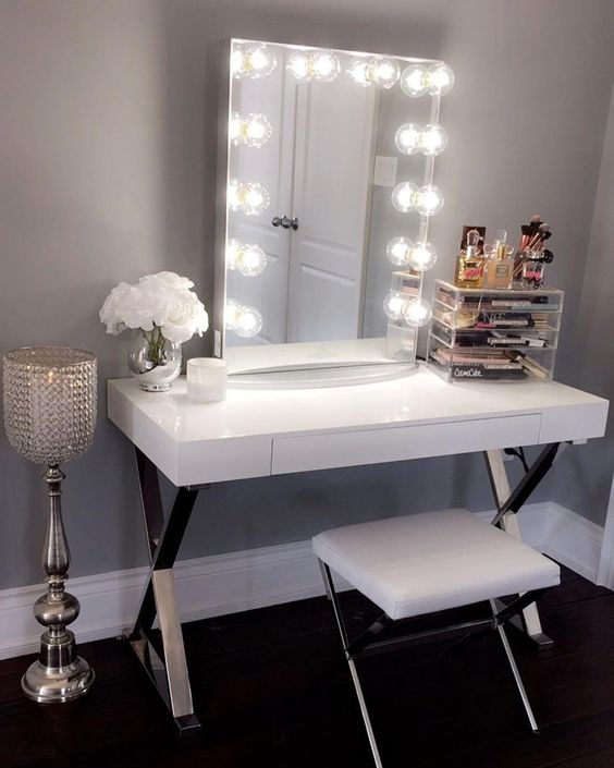 a glam sleek white vanity with metal trestle legs and a drawer for storage