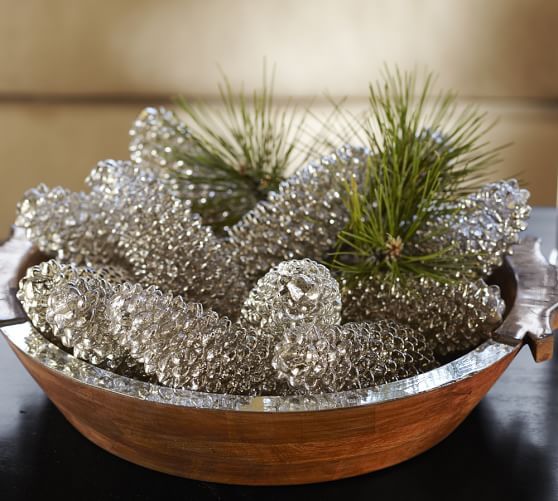 a wooden bowl with silver pinecones and pine branches for a sparkly glam look