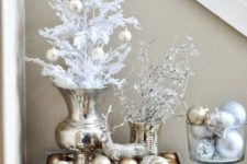 04 a glam Christmas display with gold and silver ornaments, a deer and snowy branches