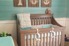 04 ocean-themed nursery with reclaimed wood artworks and a turquoise wall and bedding
