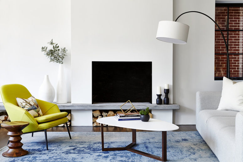 There's a built-in fireplace and a worn blue rug