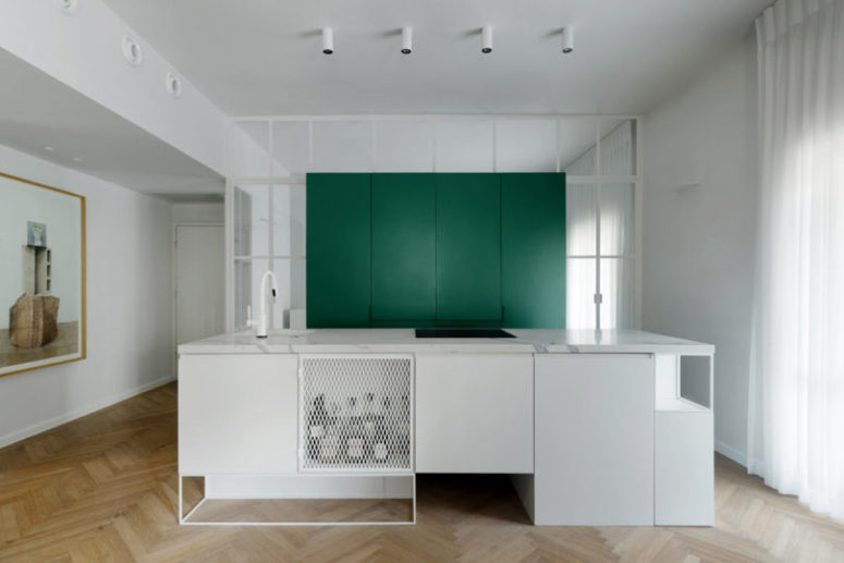 There's a large green cube for storage and a large kitchen island with lots of space for cooking