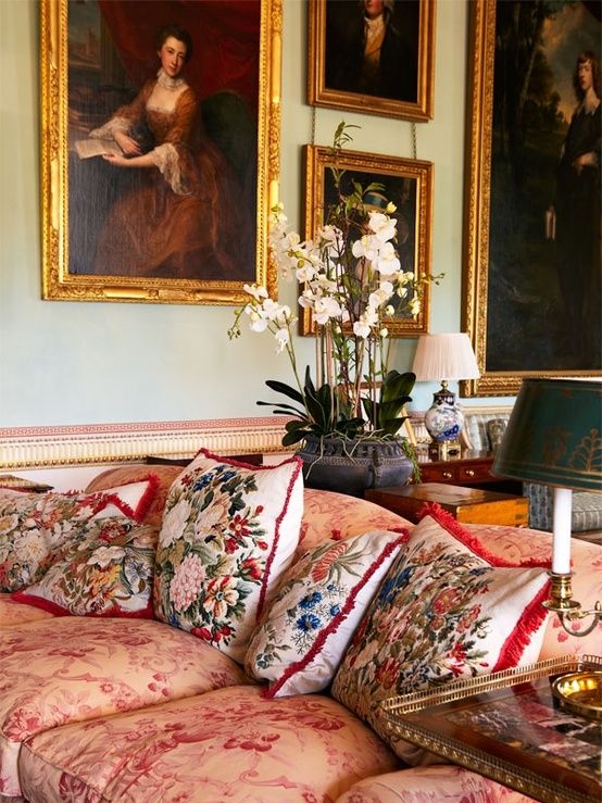 a large upholstered sofa and pillows are with different floral prints