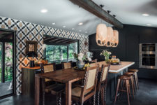 06 The kitchen is Gothic, there’s a geometric walpaper wall and sleek matte black cabinets