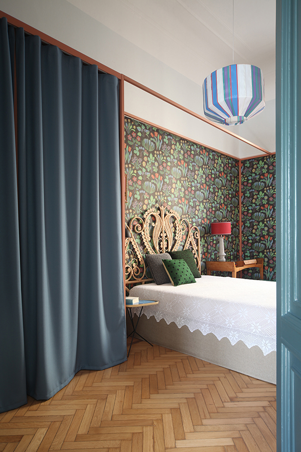 The master bedroom was done with bold flroal wallpaper and a bed with a very eye-catchy headboard
