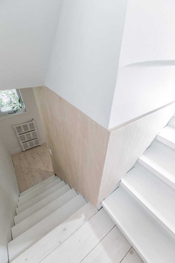 The staircase is whitewashed, and the wood is light colored too to create an airy feeling