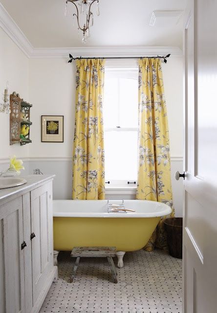 a farmhouse bathroom with yellow floral print curtains