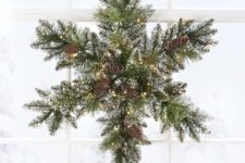 06 a snowy evergreen Christmas wreath with pinecones and lights shaped as a snowflake