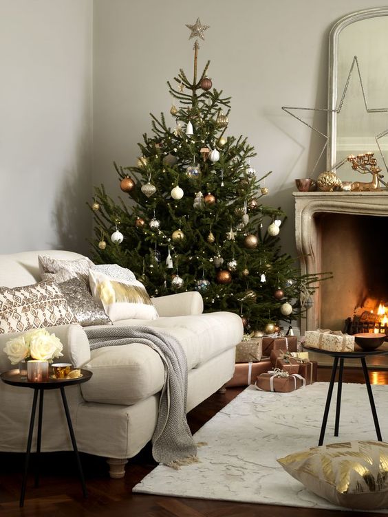 copper, silver and gold ornaments of various shapes make the tree very chic