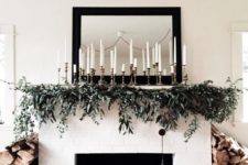 06 elegant mantel decor with an evergreen garland and lots of candles is easy to recreate and looks cool