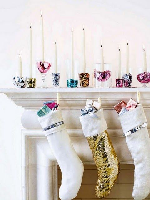 a glam display with shiny colorful candle holders and sequin stockings plus colorful gifts