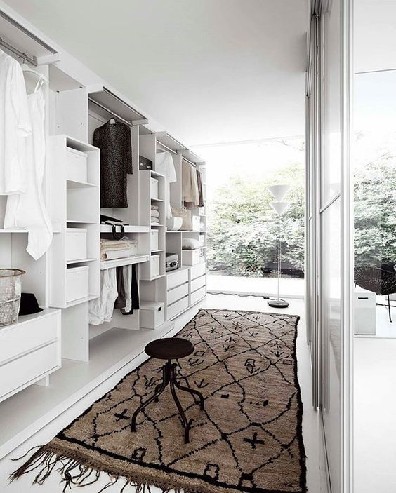 a large closet with lots of cabinets and large windows to brign much light in