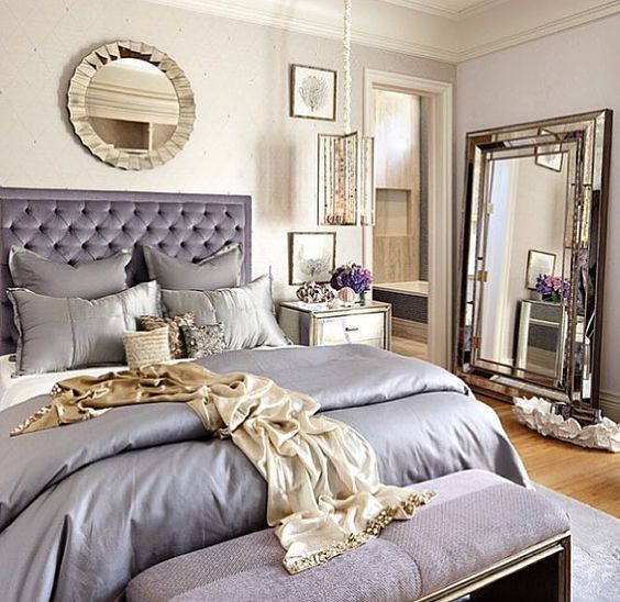a neutral bedroom with lavender touches and lots of shiny mirrors to make the space glam