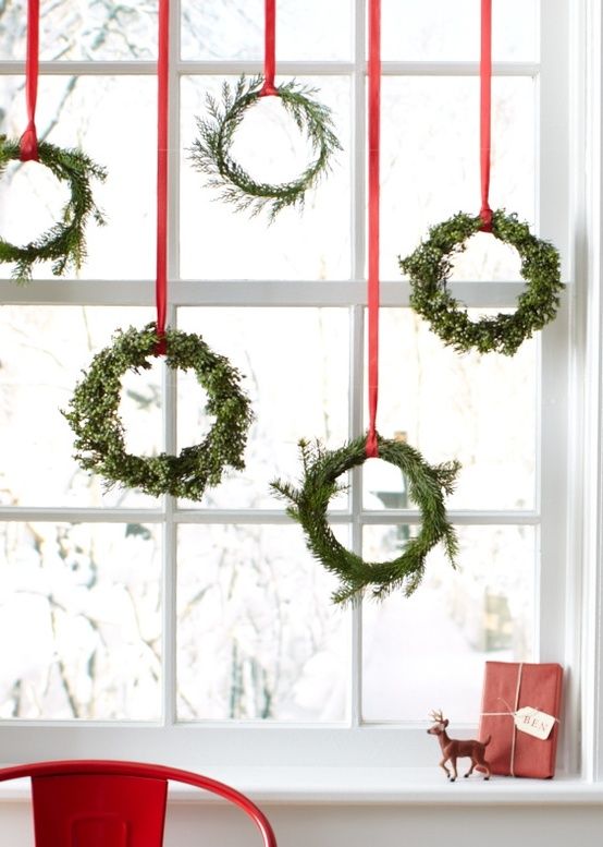 small evergreen wreaths on red ribbon will be a great idea for window decor