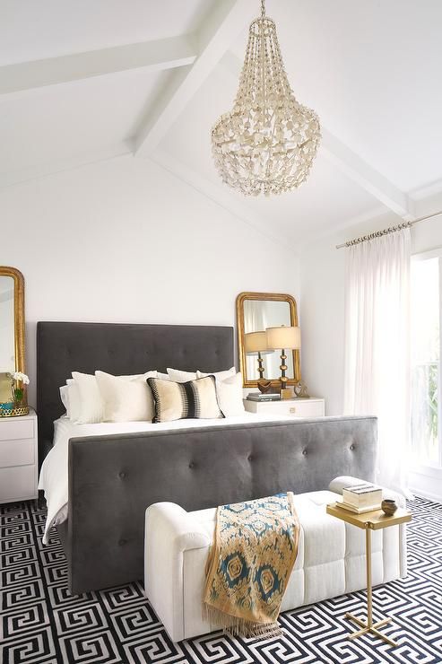 a creamy and grey bedroom is glammed up with brass touches