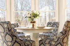 08 a traditional breakfast nook with a pedestal round table and printed upholstered chairs