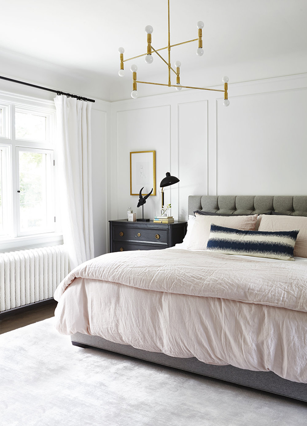 The master bedroom is done in neutrals plus grey, and there are some metallic touches for a chic look
