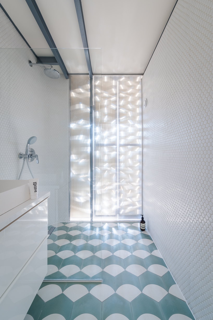 There's also an en-suite bathroom clad with white penny tiles and with a geo tiled floor