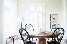 09 a large vintage wood pedestal table and vintage black chairs for an eye-catchy breakfast space